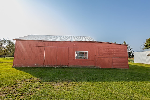 view of outbuilding featuring a lawn