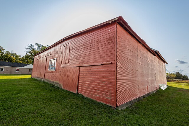 view of outbuilding featuring a lawn