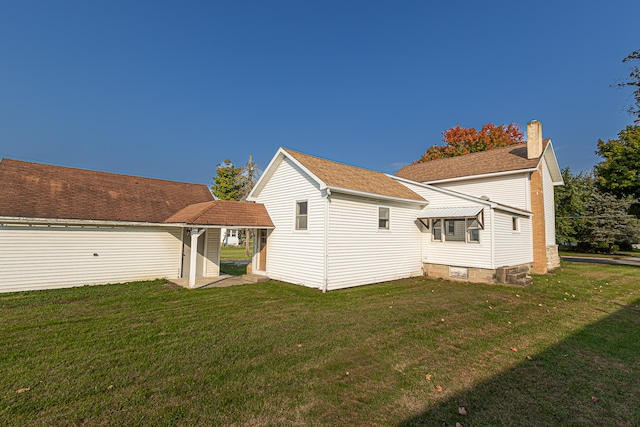 back of property featuring a lawn