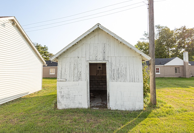 view of outbuilding featuring a yard