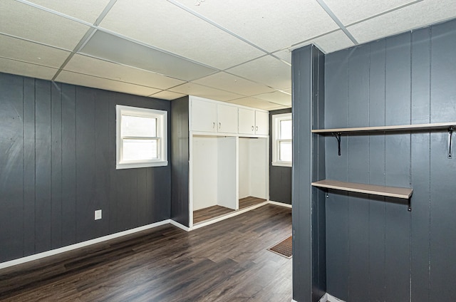 interior space featuring dark hardwood / wood-style floors and a paneled ceiling