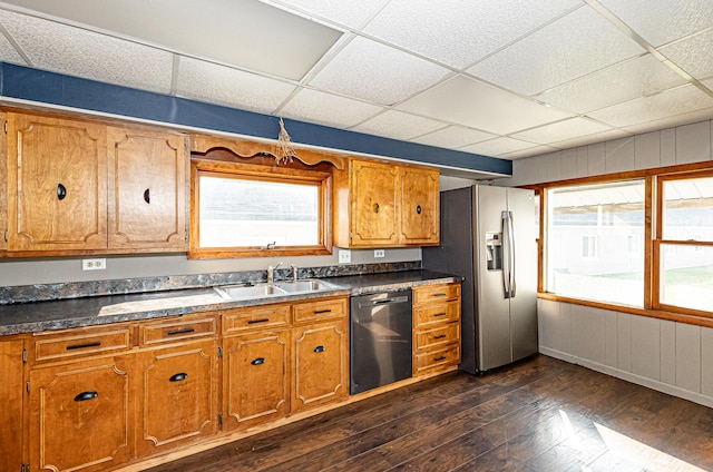 kitchen with stainless steel fridge, sink, a drop ceiling, black dishwasher, and dark hardwood / wood-style flooring