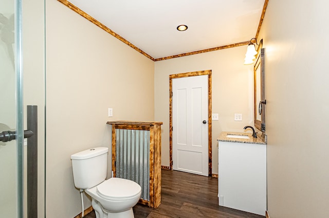 bathroom with crown molding, vanity, toilet, and hardwood / wood-style flooring