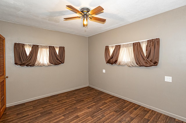 unfurnished room with ceiling fan and dark wood-type flooring