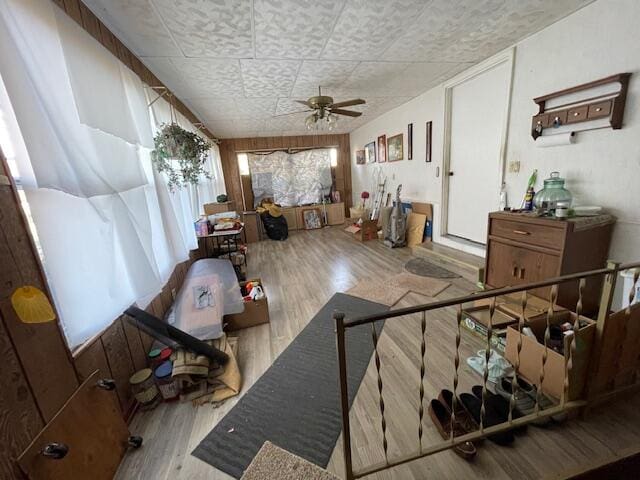 living room featuring light hardwood / wood-style floors and ceiling fan