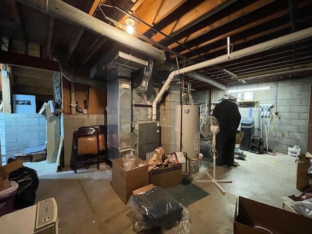 basement with water heater and heating unit