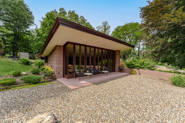 view of property exterior with a patio