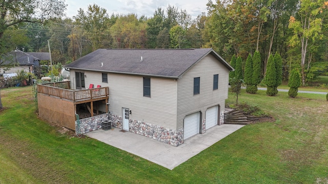 back of house with a lawn, a garage, a deck, and central AC unit