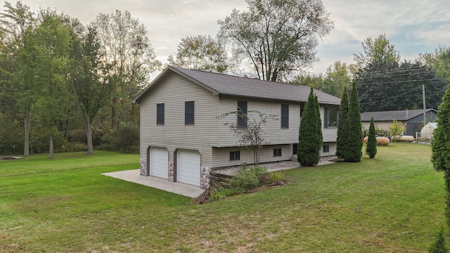 view of side of home featuring a garage and a lawn