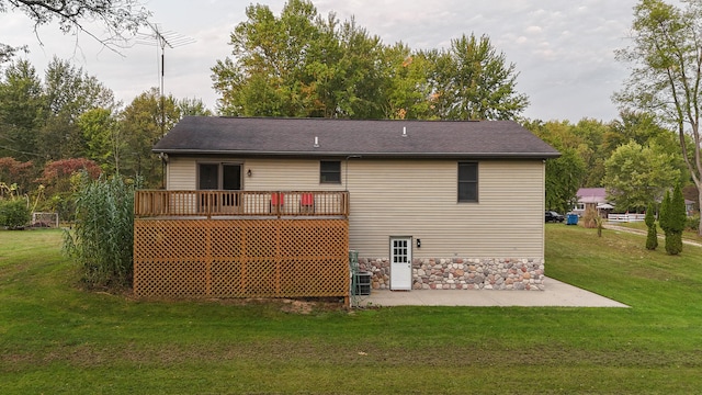 rear view of house with a deck, a yard, and a patio