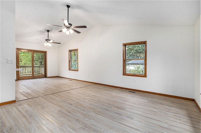 empty room with lofted ceiling, light wood-type flooring, and ceiling fan