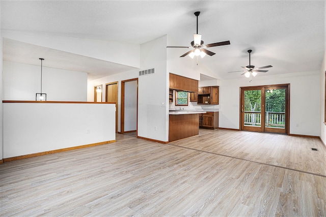 unfurnished living room with high vaulted ceiling, light wood-type flooring, and ceiling fan