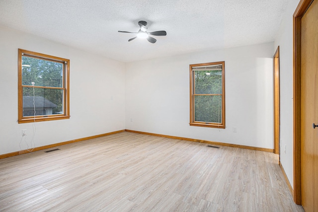 unfurnished room featuring light hardwood / wood-style floors, ceiling fan, and a textured ceiling