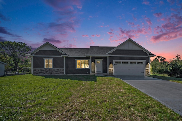 view of front of home with a garage and a yard