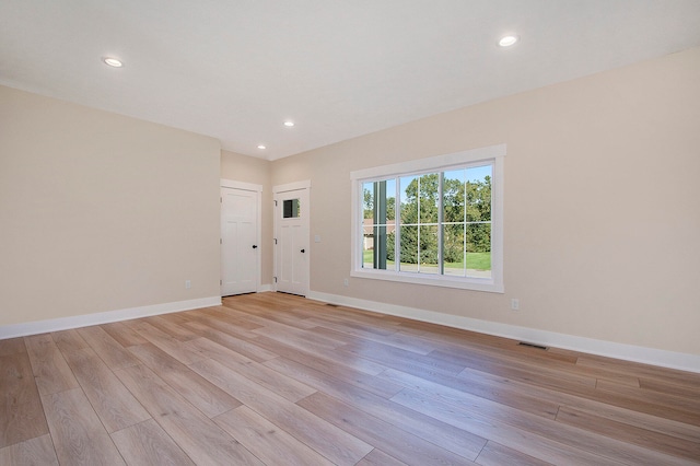 unfurnished room with light hardwood / wood-style floors