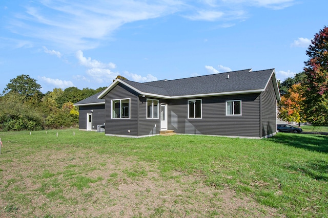 back of property featuring a lawn