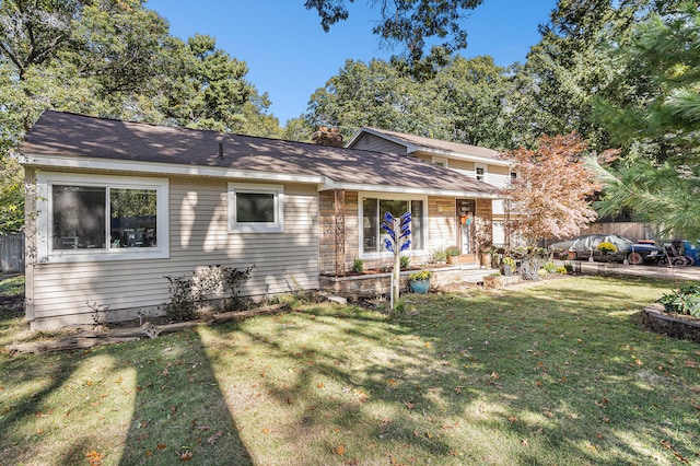 split level home featuring a front lawn