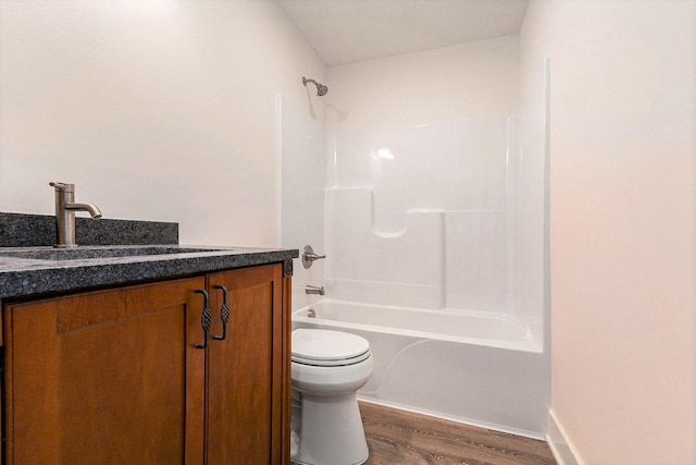 full bathroom with bathing tub / shower combination, vanity, toilet, and hardwood / wood-style flooring