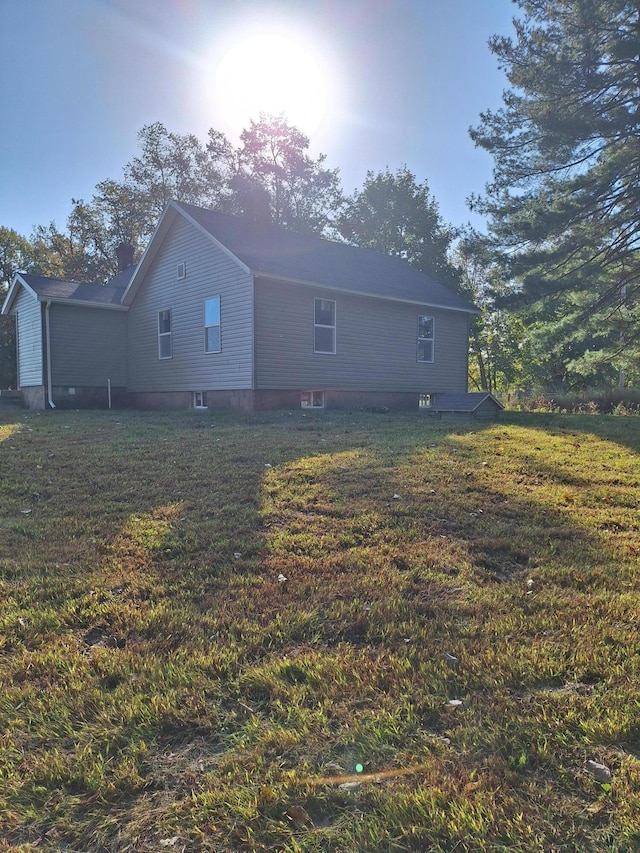 rear view of property featuring a yard