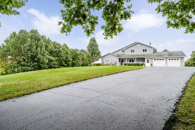 view of front of property with a front yard and a garage