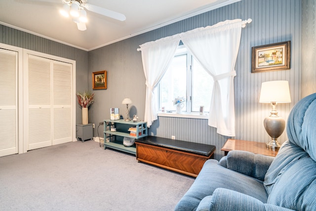 interior space with carpet floors, crown molding, and ceiling fan