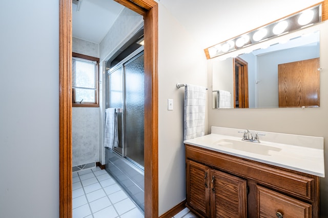 bathroom featuring enclosed tub / shower combo, vanity, and tile patterned floors