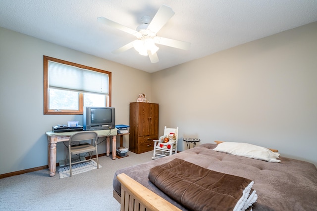 bedroom featuring a textured ceiling, carpet flooring, and ceiling fan