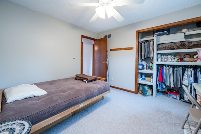 bedroom with light carpet, a closet, and ceiling fan