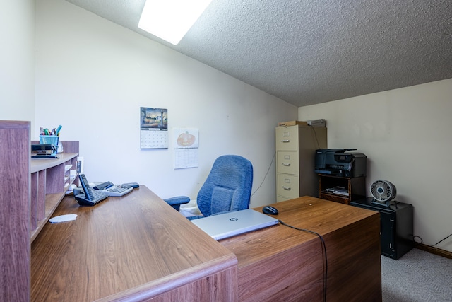 carpeted office featuring a textured ceiling