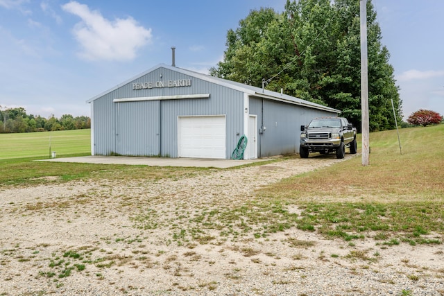 garage with wood walls and a lawn