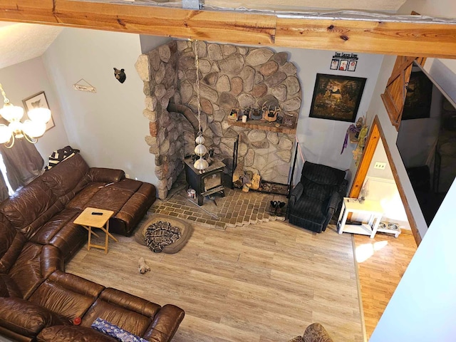 living room with a wood stove and hardwood / wood-style flooring