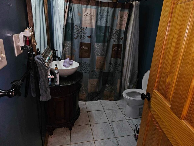 bathroom with walk in shower, vanity, and toilet