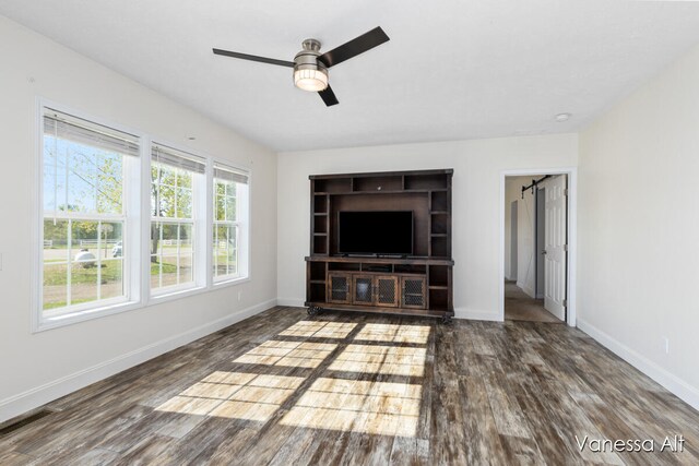 unfurnished living room featuring ceiling fan and wood-type flooring