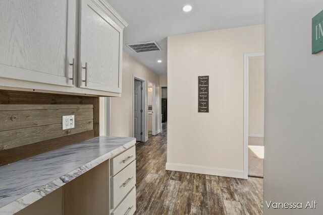 hallway with dark wood-type flooring