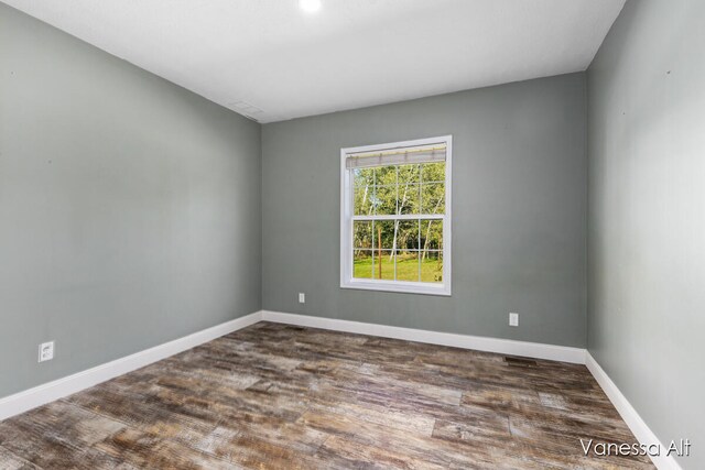 spare room featuring dark hardwood / wood-style floors