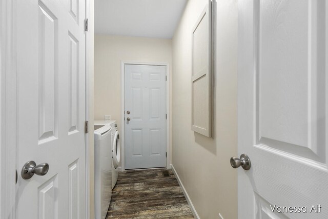 doorway with dark hardwood / wood-style flooring and independent washer and dryer