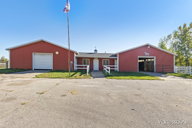 view of front of house with a garage and an outdoor structure