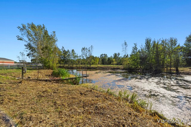 view of yard featuring a rural view and a water view