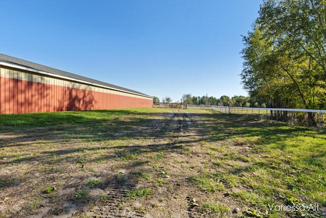 view of yard with an outbuilding and a rural view