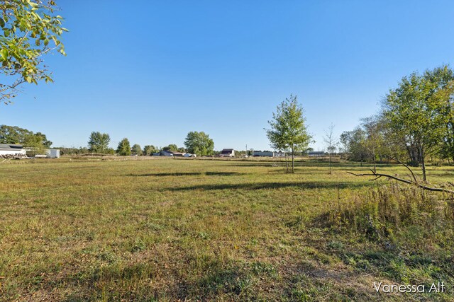 view of yard with a rural view