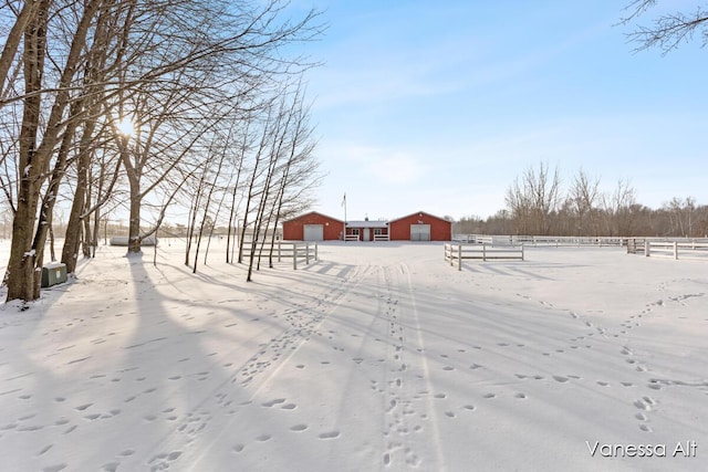 snowy yard with an outbuilding and a rural view