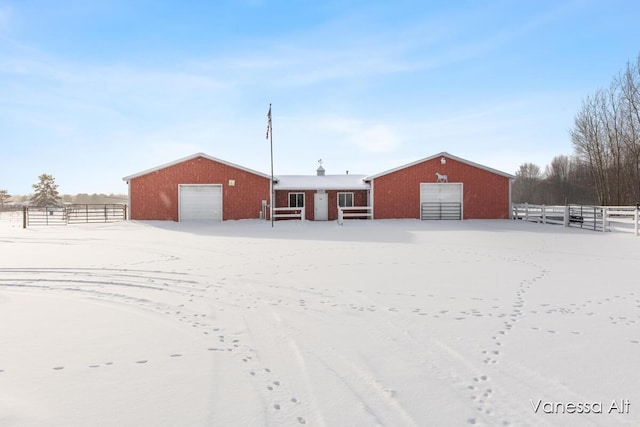 back of house featuring a garage and an outdoor structure