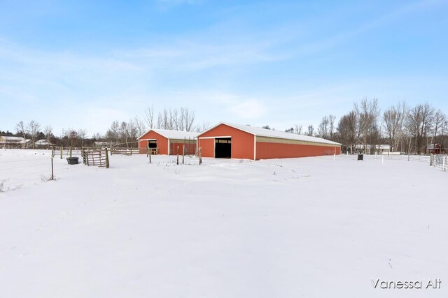 snowy yard featuring an outbuilding