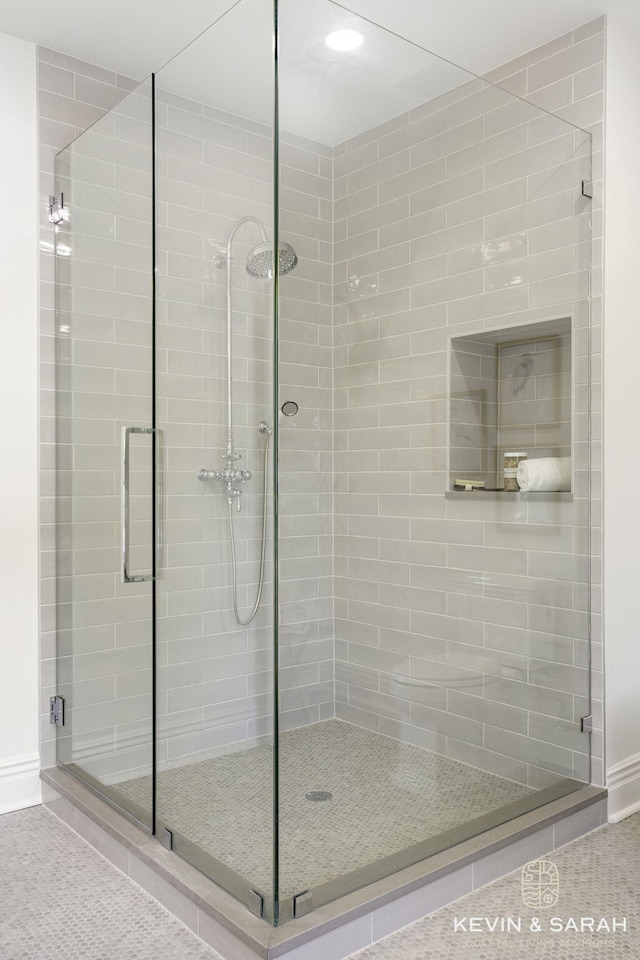 bathroom with a shower with shower door and tile patterned floors