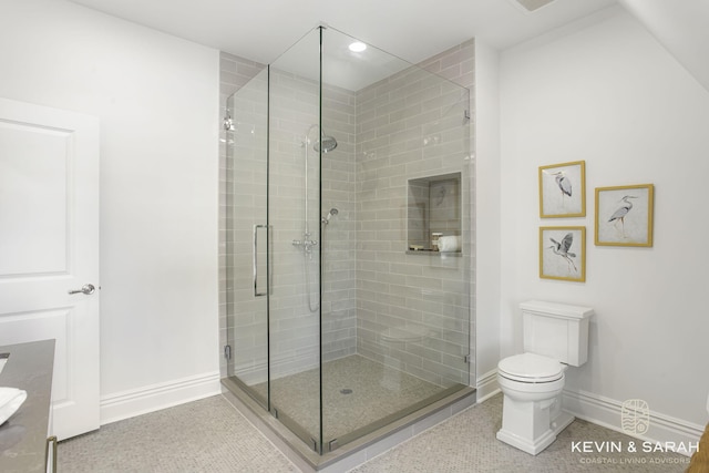 bathroom featuring vanity, toilet, and an enclosed shower