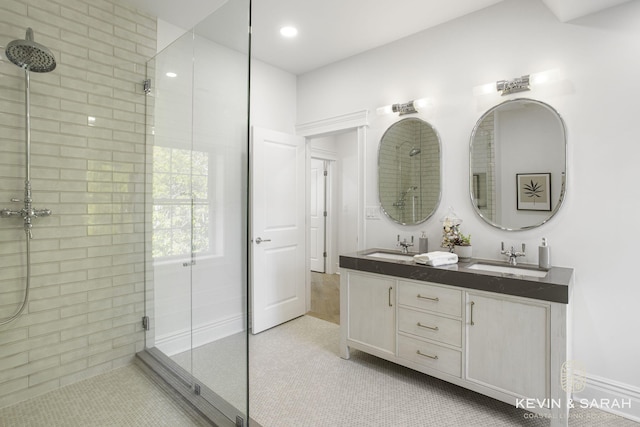 bathroom featuring vanity, walk in shower, and tile patterned flooring