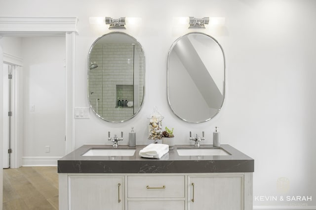 bathroom with vanity, wood-type flooring, and a shower with shower door