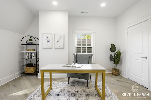 office area with wood-type flooring and vaulted ceiling