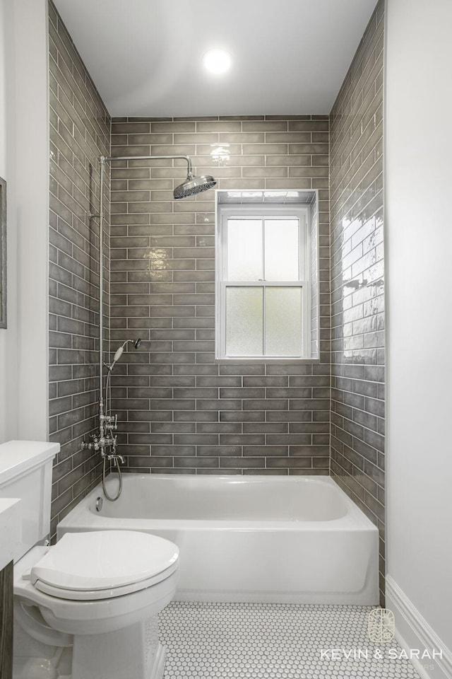 full bathroom with vanity, toilet, tile patterned floors, and tiled shower / bath combo