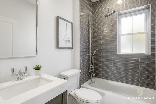 full bathroom featuring toilet, tiled shower / bath combo, and vanity